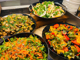 Healthy school meals served at The Rural Enterprise Academy, featuring a variety of nutritious dishes including salads and vegetable-rich options.